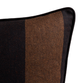 Corner detail of a rectangular woven pillow cover with wide vertical stripes in Java brown and black, featuring black piping along the edge.