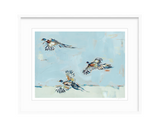 Fine art print depicting three pheasants in mid-flight against a soft blue and whitish abstract background with loose brushstrokes, framed in white.