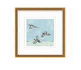 Painting of three flying pheasants with detailed feathers on a light blue and white abstract sky background in a gold frame with white matting.