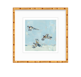 Framed fine art print featuring three flying pheasants with patterned feathers against a sky-blue and pale background, bordered by a wide white mat and bamboo-style frame.