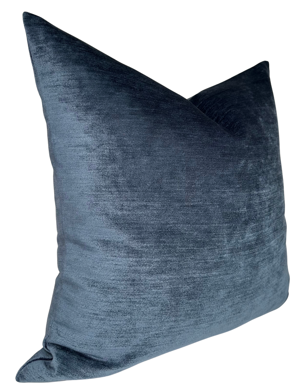 Square sapphire blue velvet pillow cover with a soft sheen and subtle texture, shown angled to highlight its plush fabric.