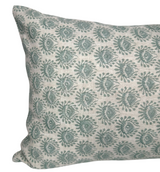 Rectangular pillow cover with repeating celadon green floral motifs on a natural beige textured fabric, shown at an angled close-up view.