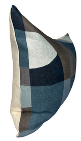 Rectangular pillow with a geometric pattern in shades of indigo, blue, brown, and beige, shown from a side angle against a white background.