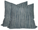 Two square pillow covers with narrow vertical stripes in Indian teal and off-white, showing a soft texture and slight creases on the fabric.