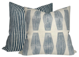 Two decorative pillows with Indian teal patterns; one has vertical ticking stripes and the other features a geometric tribal-inspired design on an off-white background.