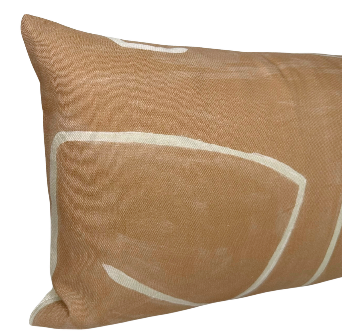 Rectangular salmon cream pillow featuring abstract white graffito-style line shapes on textured fabric surface.
