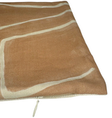 Close-up of a salmon cream pillow cover with an abstract cream line pattern and a visible zipper along one edge.