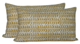 Two rectangular saffron pillow covers with horizontal white vine patterns repeating across their fabric.