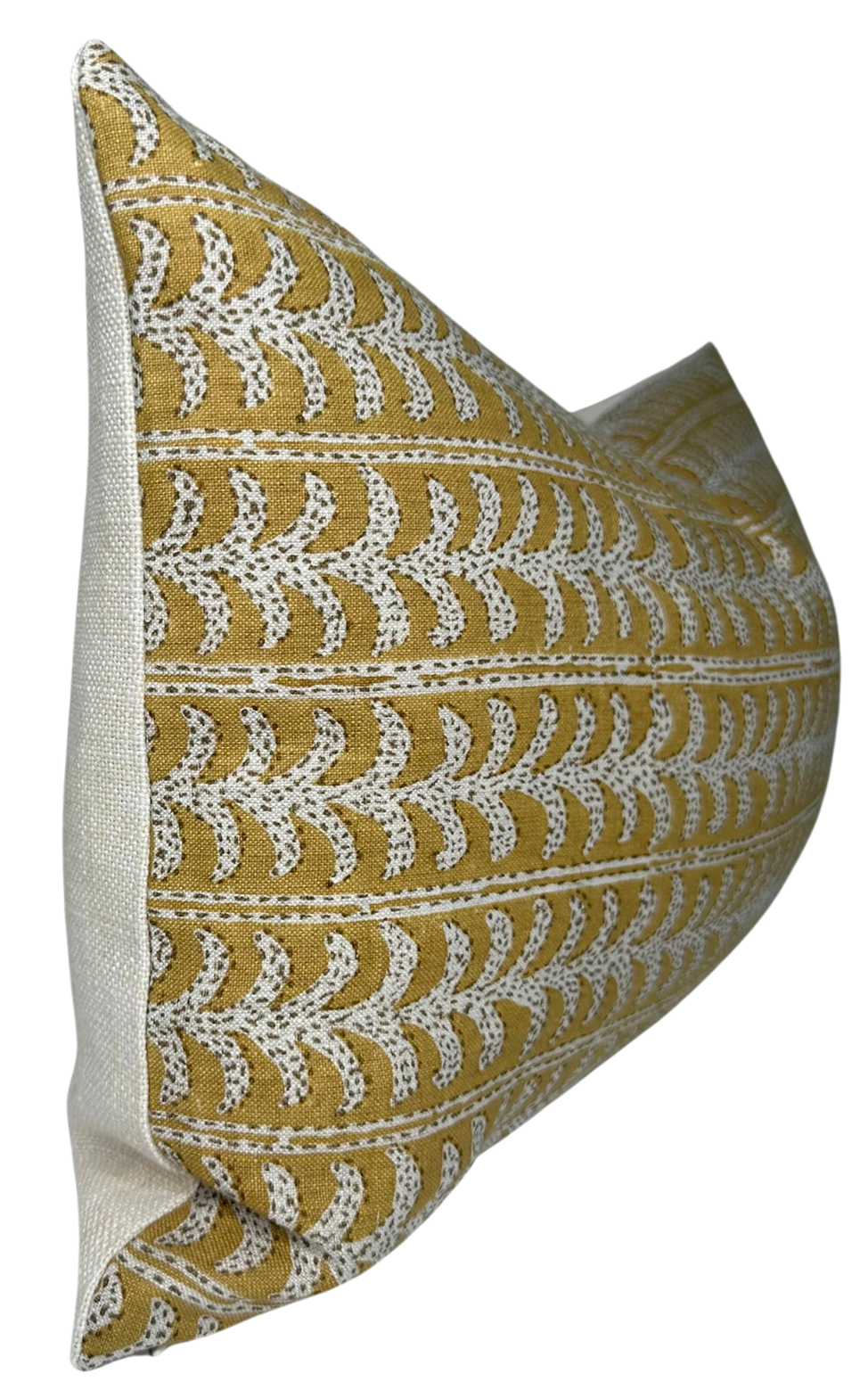 Rectangular pillow cover in saffron yellow with repeating white fern-like patterns and cream-colored fabric on the sides, shown at a three-quarter angle.