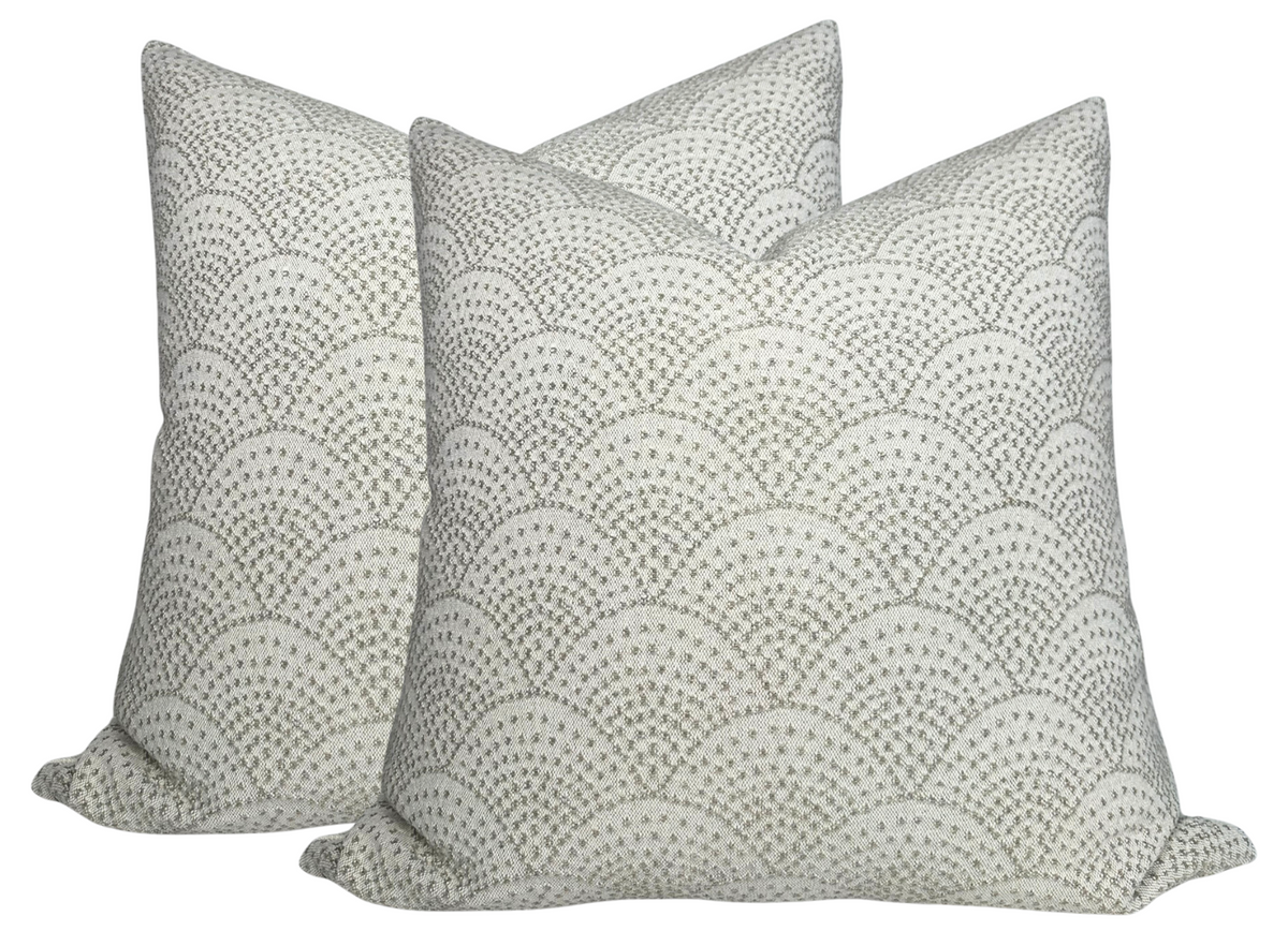 Two square pillow covers with a natural background and gray scalloped woven pattern forming repeating arches