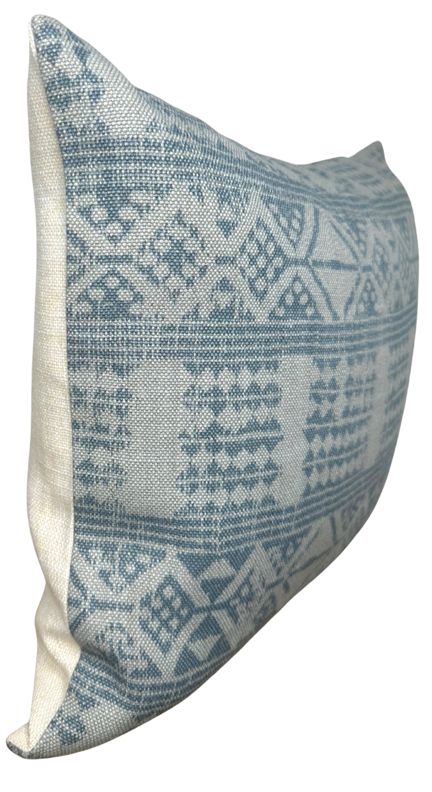 Rectangular pillow cover with a soft mist blue and cream geometric pattern on a textured fabric, shown from a side angle highlighting its thickness and shape.