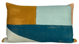 Rectangular pillow cover with a modern geometric patchwork of ochre, light blue, off-white, and deep teal fabric sections.