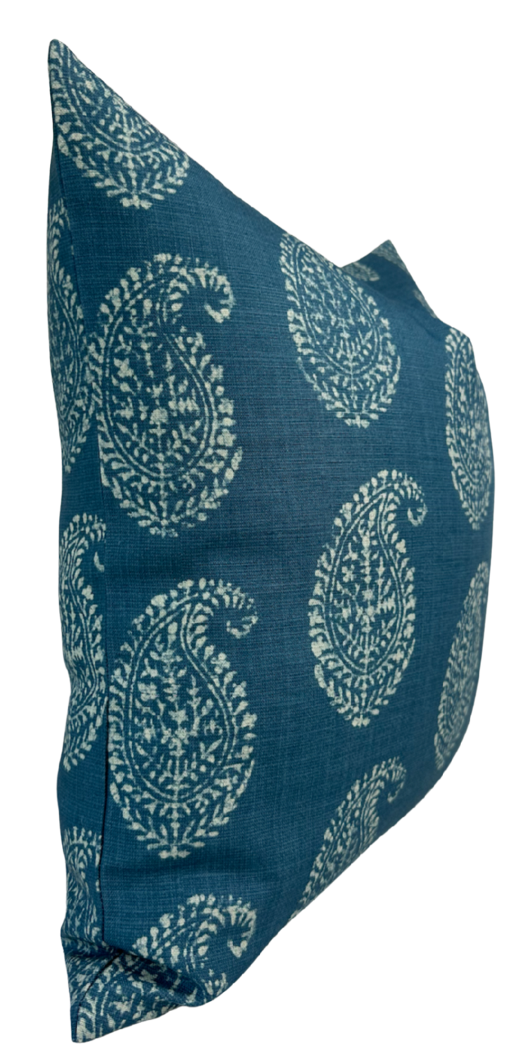 Blue pillow cover with white Kashmir paisley floral pattern, shown at an angled side view highlighting its texture and print.