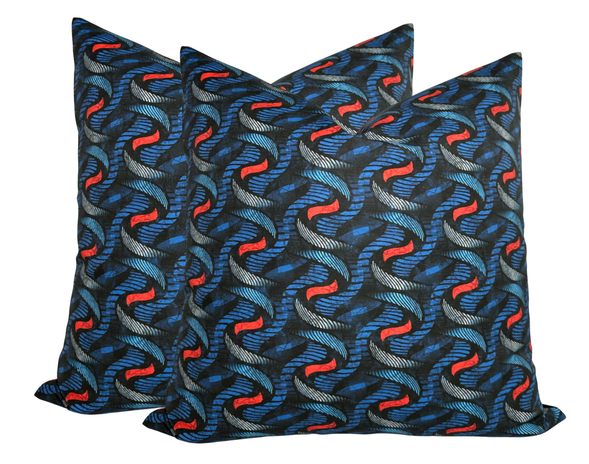 Three indigo pillow covers with a repeating twine pattern in blue and bold red accents on a dark background.
