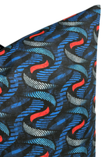 Close-up of a pillow corner featuring an indigo fabric with a twisting twine pattern in red, white, and shades of blue on a dark background.