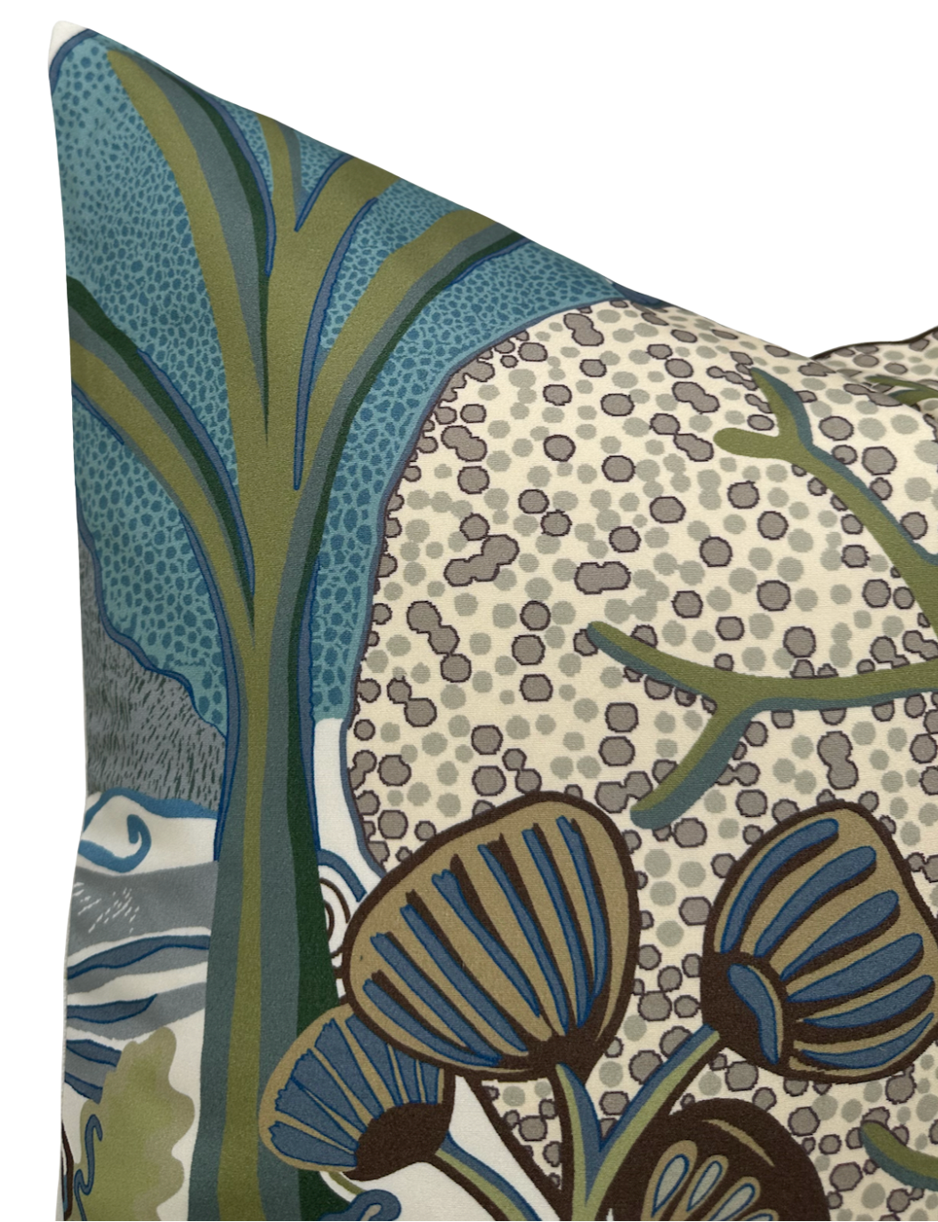 Corner of a pillow cover featuring an abstract botanical pattern with large stylized blue and olive-green leaves against a beige background with scattered gray dots.