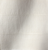 Close-up of sandstone-colored fabric with a subtle woven texture and two faint horizontal stitched lines evenly spaced apart.
