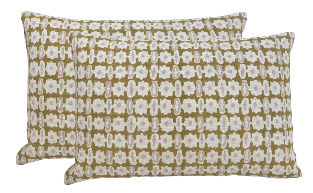 Two rectangular pillows with a repeating abstract pattern of white and light brown shapes on a saffron-colored background, arranged overlapping.