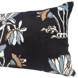 Rectangular pillow cover with black background and a floral lily pattern in blue, white, and brown shades.