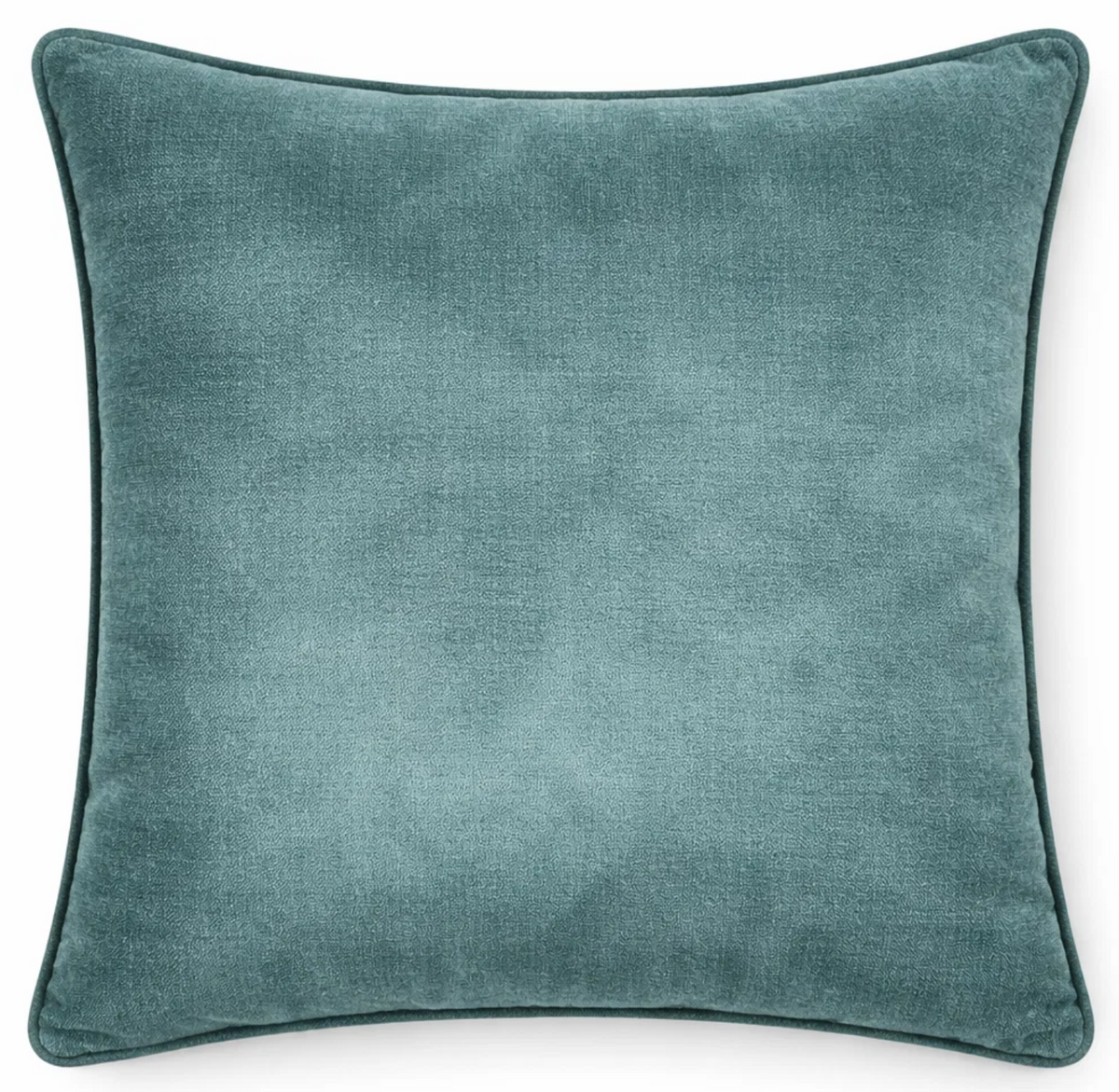 Montage Velvet Pillow Cover in rich teal shown on a sofa cushion.