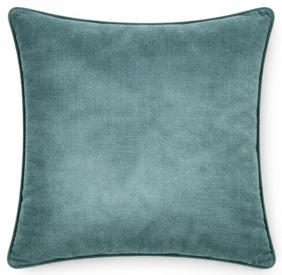 Montage Velvet Pillow Cover in rich teal shown on a sofa cushion.