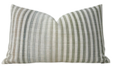 Pharos Pillow Cover in green displayed on sofa with layered cushions