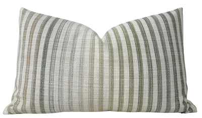 Pharos Pillow Cover in green displayed on sofa with layered cushions