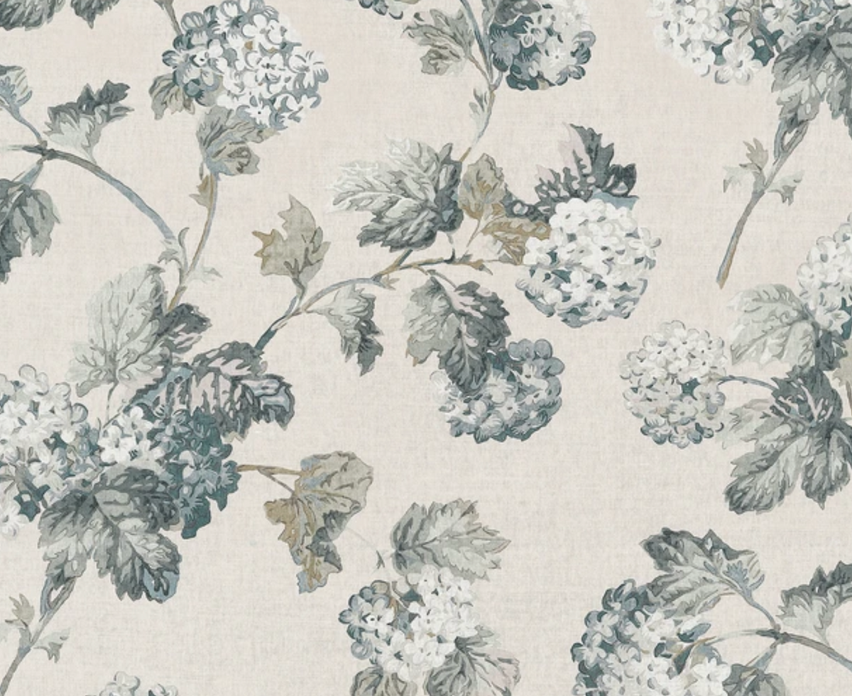 Pattern of slate and blue hydrangea clusters with detailed leaves on a soft beige background, showing a classic botanical textile design.
