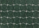 Close-up of seafoam green velvet fabric with interlocking geometric hexagon patterns creating a textured, plush surface.