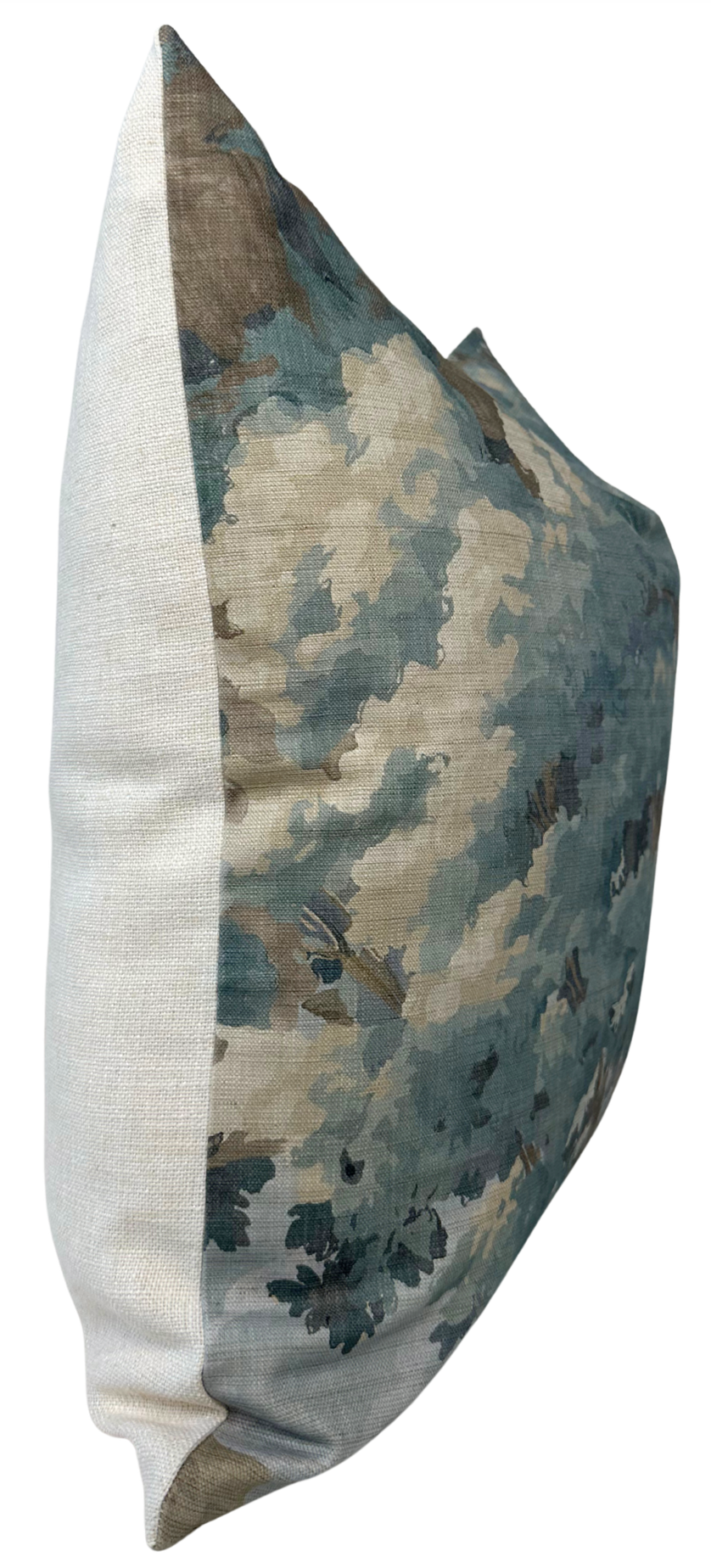 Rectangular pillow with off-white textured fabric on the sides and a woodland-inspired floral print in muted spa blue, beige, and green tones on the front.