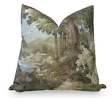 Square pillow with a printed design of a woodland scene featuring green foliage, tree trunks, and a distant body of water under a pale blue sky.