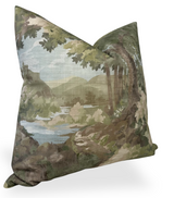 Square pillow cover featuring a green woodland clearing scene with large tree trunks, leafy branches, and a distant blue lake under a light blue sky.