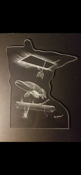 Clear acrylic cutout shaped like Minnesota, etched with an underwater scene of a fish near a spear floating above logs, outlined and detailed in white.