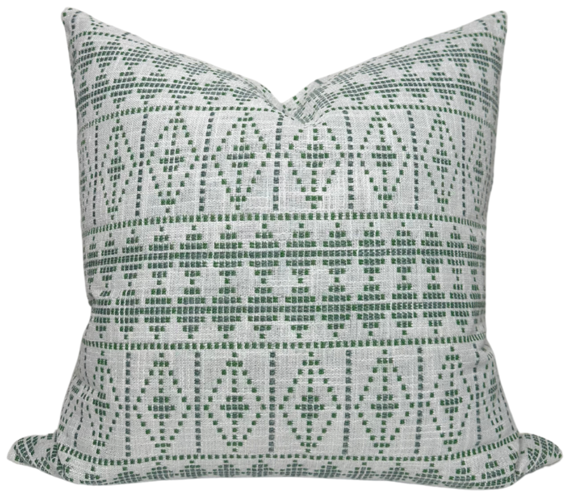 Green Souk Pillow Cover made of woven fabric by Peter Dunham displayed on sofa.