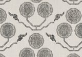 Light beige fabric with a repeating pattern of dark grey octagonal shapes connected by zigzag lines and paired with wing-like motifs.