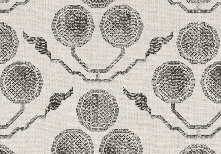 Light beige fabric with a repeating pattern of dark grey octagonal shapes connected by zigzag lines and paired with wing-like motifs.