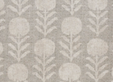 Fabric with a sand grey background featuring a repeating pattern of stylized, textured zinnia flowers and vertical leafy stems in a lighter beige color.