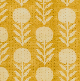 Goldenrod fabric with vertical rows of white stylized zinnia flowers and leafy stems, featuring a dotted texture throughout.