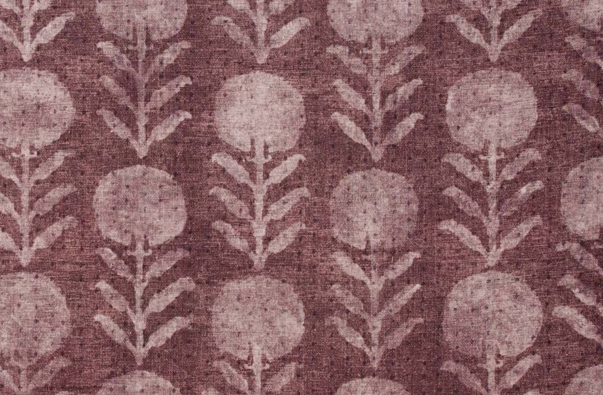 Berry-colored fabric with a repeating pattern of stylized zinnia flowers featuring circular blooms and vertical leaf stems in lighter pink hues.