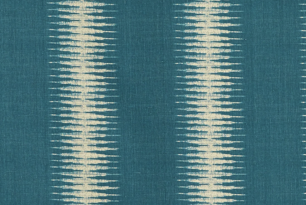 Teal fabric with vertical cream-colored ikat patterns featuring symmetrical, elongated diamond shapes in repeating columns.