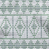 Light-colored woven fabric with green geometric diamond and rectangular patterns creating a textured, tribal-inspired design.