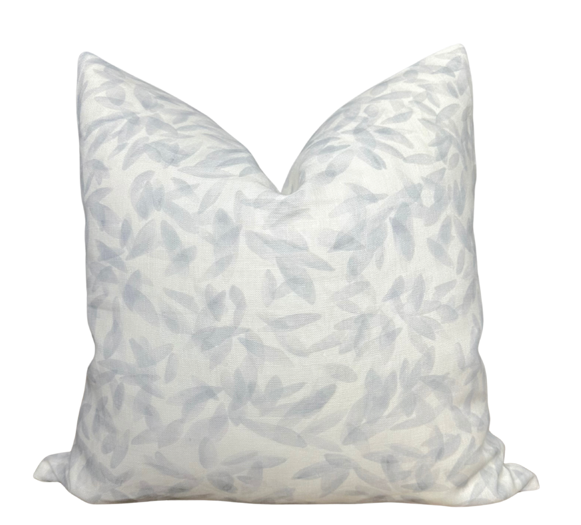 Marbella Pillow Cover in Smoke displayed on a chair with a neutral interior background
