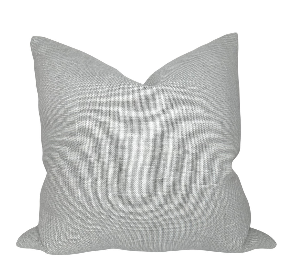 Mia Linen Pillow Cover in Pierre displayed on a couch with ivory linen backing visible