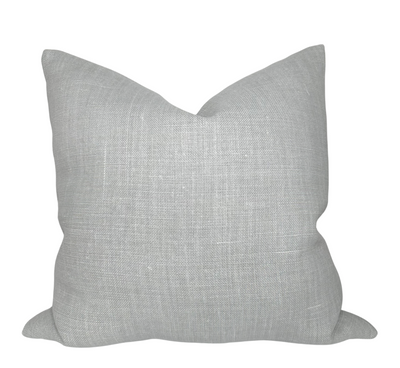 Mia Linen Pillow Cover in Pierre displayed on a couch with ivory linen backing visible