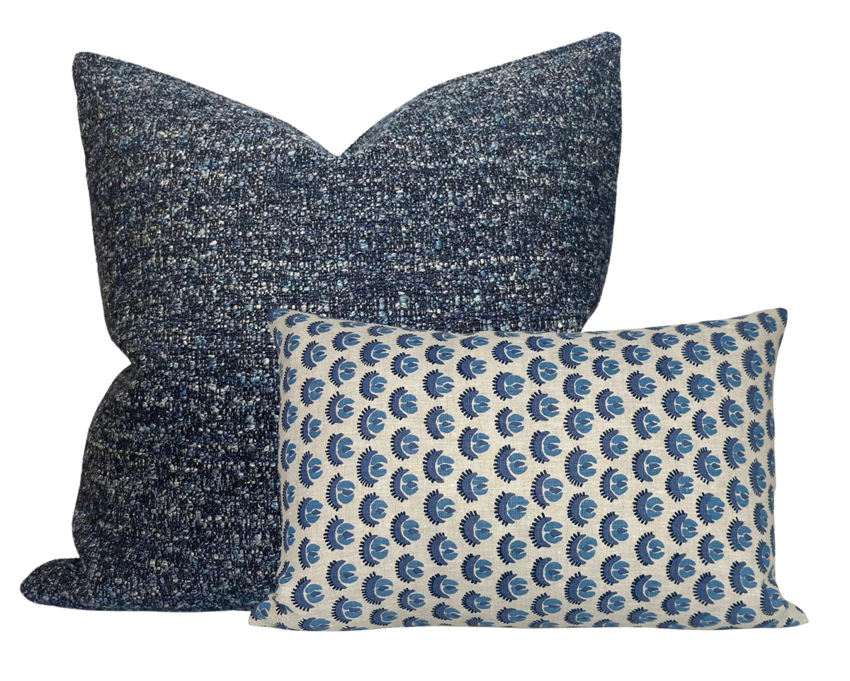 Two Cadiz pillow covers by Walter G Textiles, one large square in textured blue fabric and one smaller rectangular with blue and white repeating pattern.