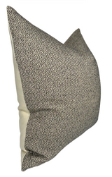 Rectangular pillow cover with a nubby charcoal and beige woven front and smooth beige fabric on the sides, shown at a slight angle.