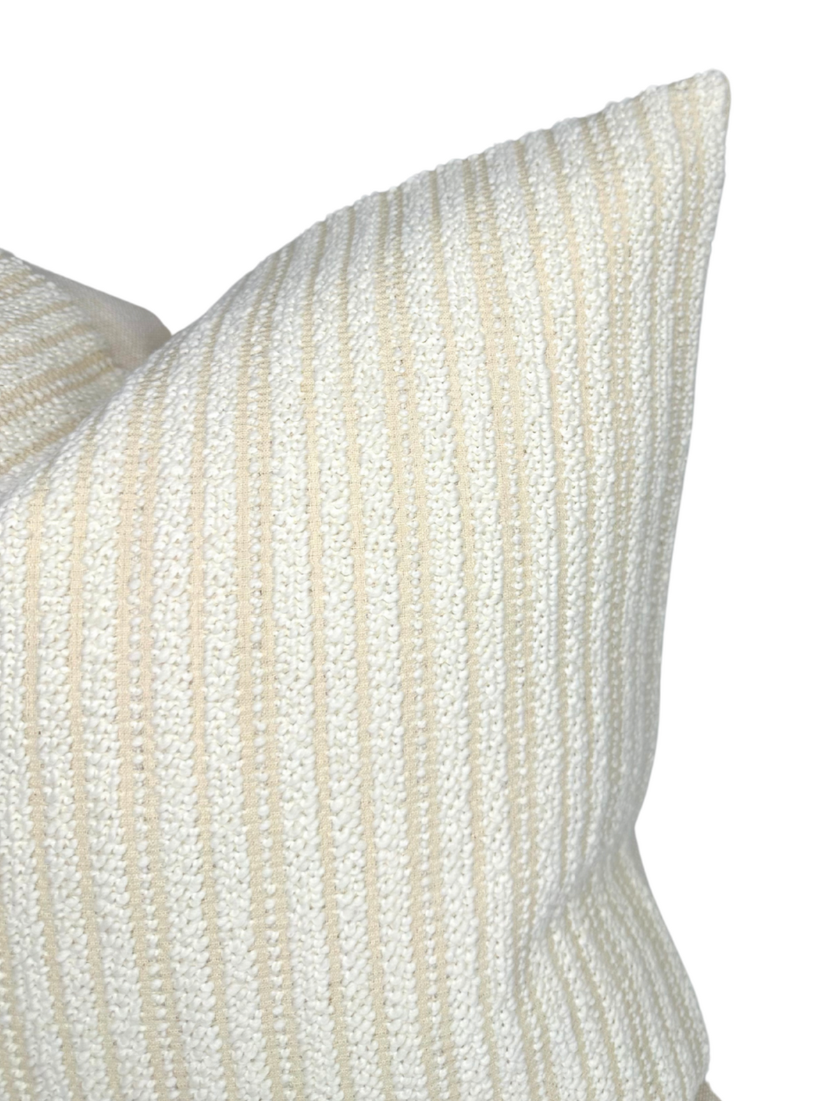 Close-up of a woven pillow cover in ecru with subtle vertical stripes in cream and beige, showing detailed texture and soft fabric folds.