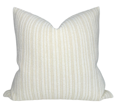 Divide Woven Pillow Cover in Ecru laying on a sofa with complementary neutral decor