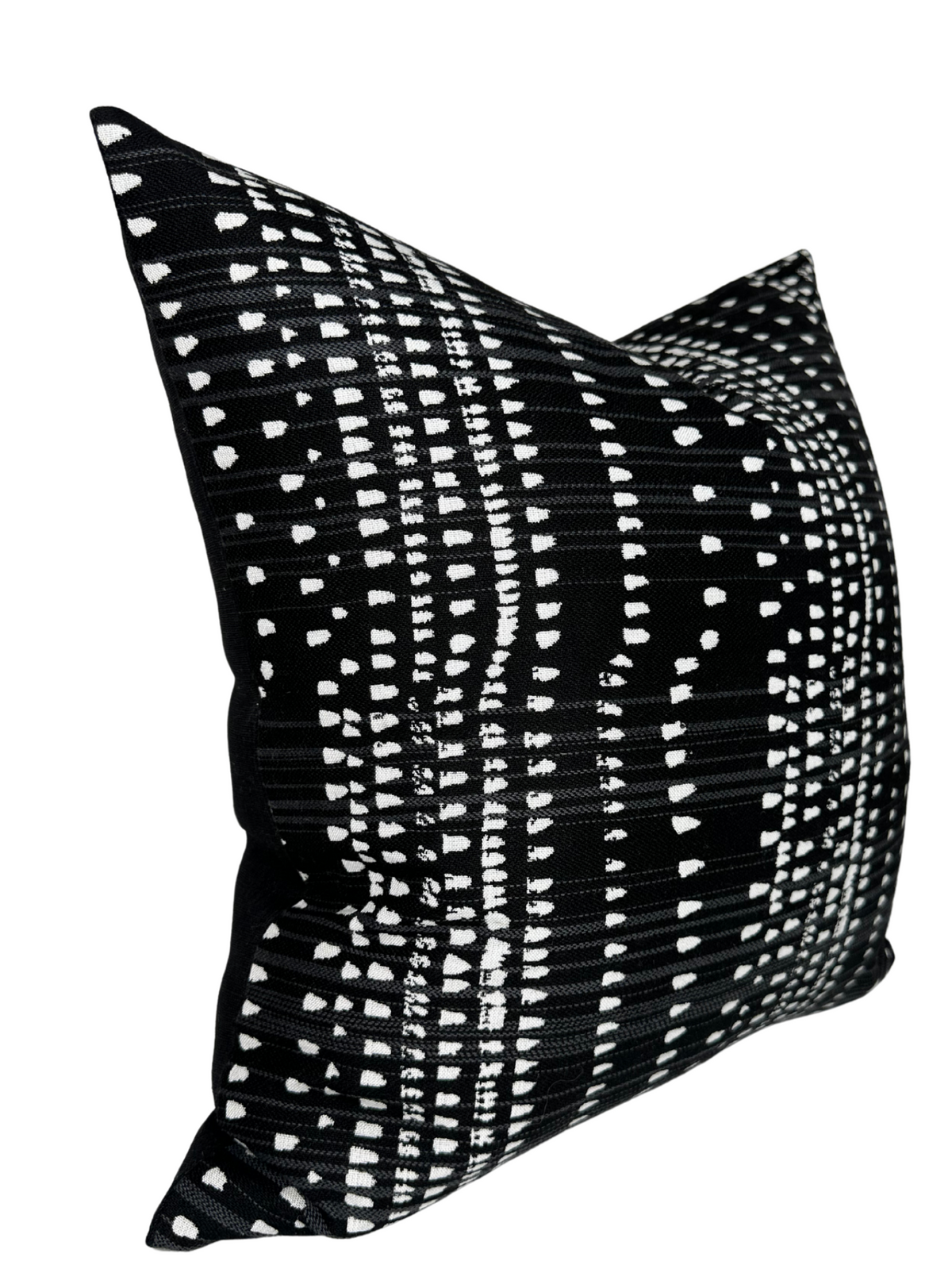 Square black pillow with a linear white dashes pattern creating horizontal and vertical grid lines, displayed at a slight angle.