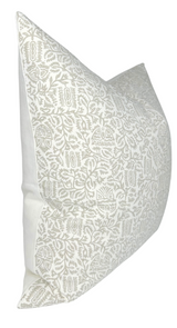 Soft taupe pillow cover featuring intricate Morris-inspired floral and geometric patterns on a creamy white background, shown from an angled side view.